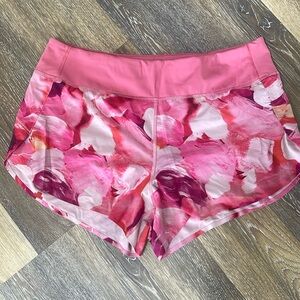 Athleta Run With It shorts in salmon pink brush stroke pattern